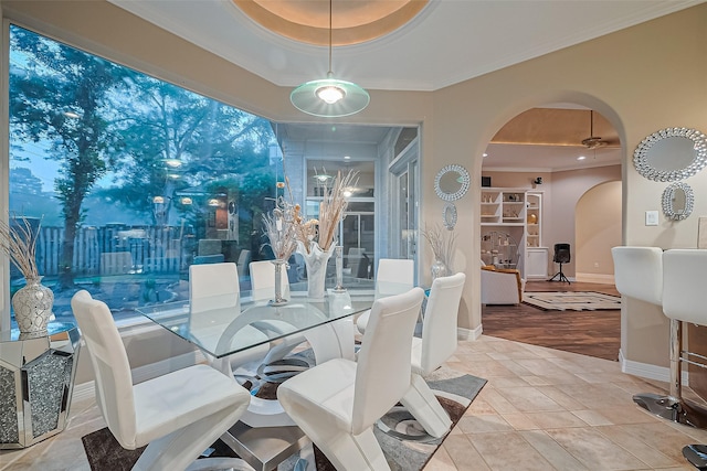 122 Marble Staff Ct, Houston, TX 77069 - dining area featuring arched walkways, a raised ceiling, crown molding, and baseboards