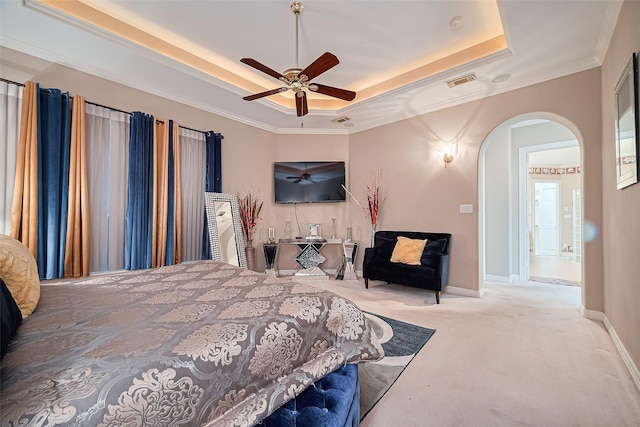 122 Marble Staff Ct, Houston, TX 77069 - carpeted bedroom featuring a raised ceiling, arched walkways, ornamental molding, ceiling fan, and baseboards