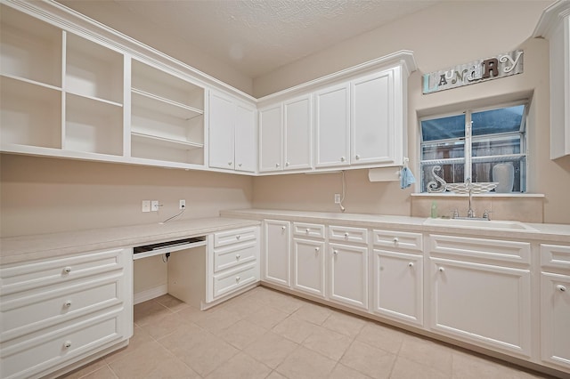 122 Marble Staff Ct, Houston, TX 77069 - unfurnished office featuring a sink, built in study area, light tile patterned floors, and a textured ceiling