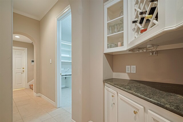 122 Marble Staff Ct, Houston, TX 77069 - corridor featuring light tile patterned floors, arched walkways, and crown molding