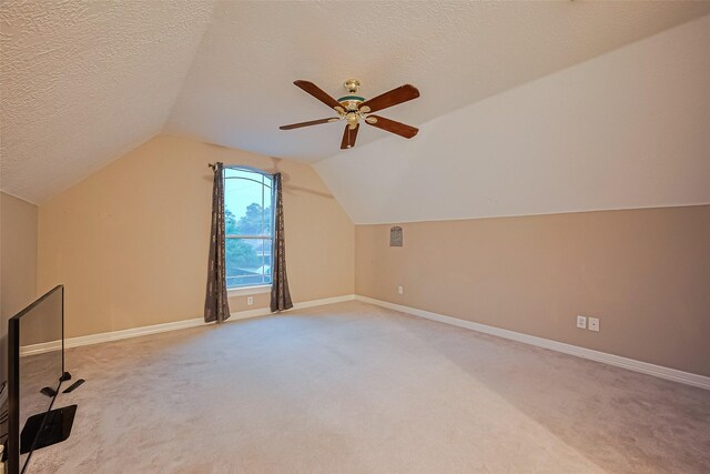 122 Marble Staff Ct, Houston, TX 77069 - bonus room with light carpet, vaulted ceiling, baseboards, and a textured ceiling