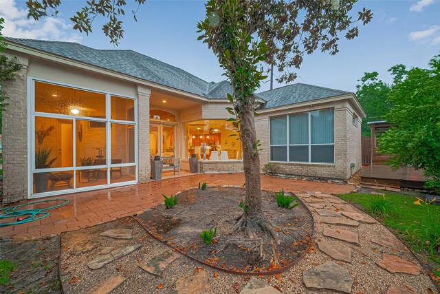 122 Marble Staff Ct, Houston, TX 77069 - back of house featuring a patio area, a shingled roof, and brick siding
