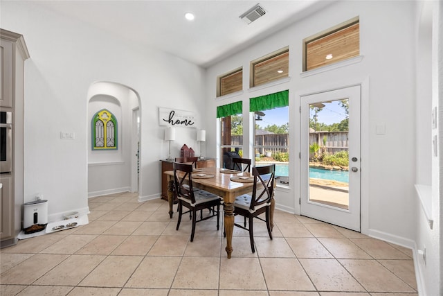 15306 Clearhaven Ct, Cypress, TX 77429 - dining room featuring light tile patterned flooring, arched walkways, visible vents, and recessed lighting