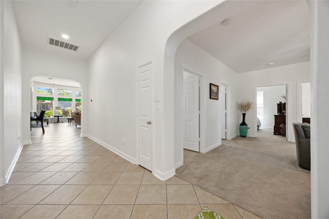 15306 Clearhaven Ct, Cypress, TX 77429 - hall featuring baseboards, arched walkways, light tile patterned floors, and visible vents