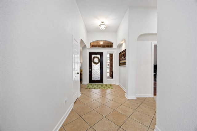 15306 Clearhaven Ct, Cypress, TX 77429 - entrance foyer with arched walkways, baseboards, and light tile patterned flooring