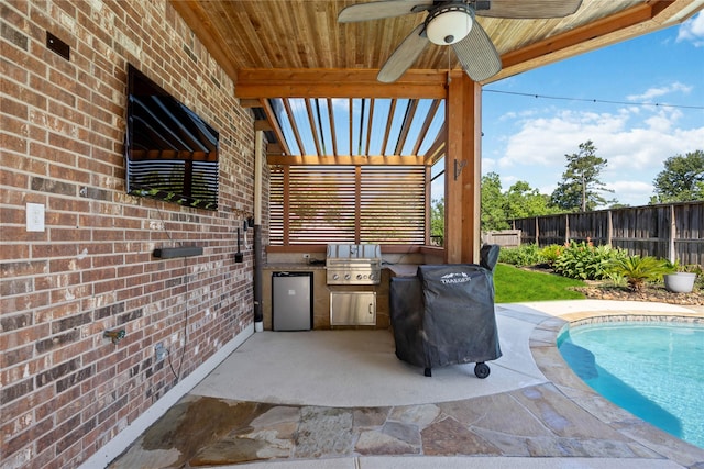 15306 Clearhaven Ct, Cypress, TX 77429 - view of patio / terrace with a fenced backyard, an outdoor kitchen, a ceiling fan, and a grill