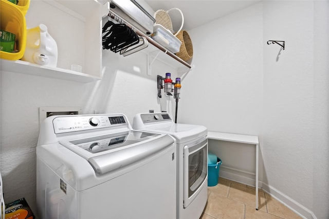 15306 Clearhaven Ct, Cypress, TX 77429 - clothes washing area featuring baseboards, laundry area, light tile patterned flooring, and independent washer and dryer