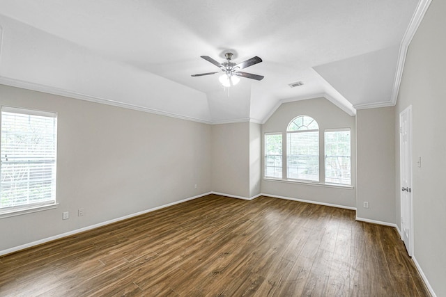 unfurnished room featuring lofted ceiling, visible vents, a ceiling fan, dark wood-style floors, and baseboards