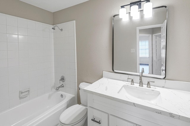 full bathroom featuring toilet, vanity, tub / shower combination, and a textured wall