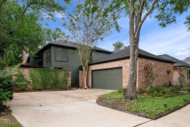 view of front of home featuring brick siding, an attached garage, and concrete driveway