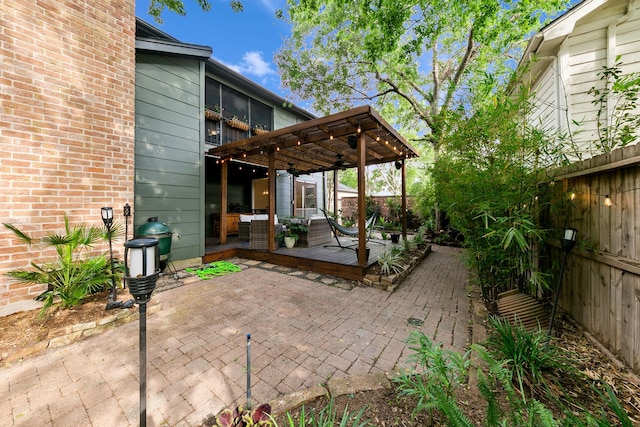 view of patio / terrace with a deck, a pergola, and a fenced backyard
