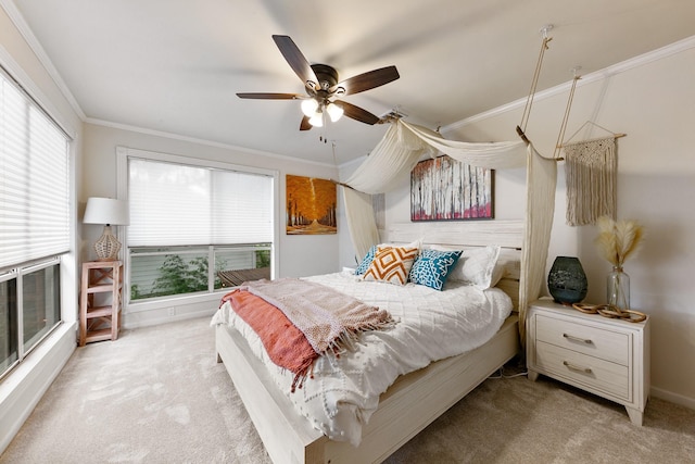 carpeted bedroom featuring crown molding, ceiling fan, and baseboards