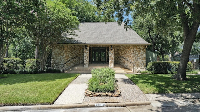 bungalow-style home featuring stone siding, french doors, and a shingled roof