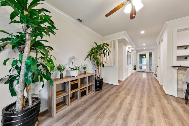hallway with wood finished floors, crown molding, recessed lighting, and baseboards