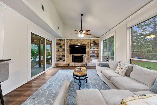 living area with lofted ceiling, ceiling fan, built in shelves, wood finished floors, and a fireplace