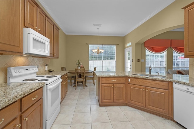 kitchen with brown cabinetry, white appliances, ornamental molding, a sink, and tasteful backsplash