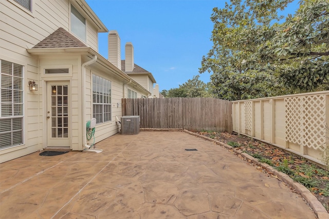 view of patio / terrace with a fenced backyard and central air condition unit
