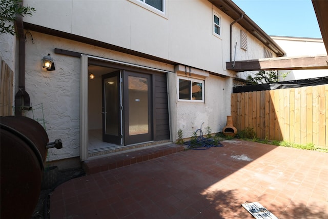 7521 Beaudelaire Cir, Galveston, TX 77551 - back of property with a patio, fence, and stucco siding