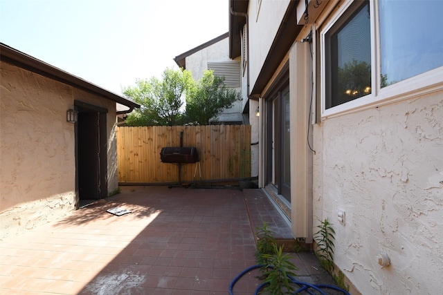7521 Beaudelaire Cir, Galveston, TX 77551 - view of property exterior with stucco siding, fence, and a patio area
