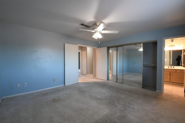 7521 Beaudelaire Cir, Galveston, TX 77551 - unfurnished bedroom with a sink, light carpet, baseboards, and ensuite bath