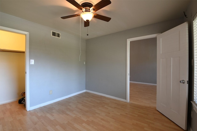 7521 Beaudelaire Cir, Galveston, TX 77551 - unfurnished bedroom featuring light wood-style floors, baseboards, a ceiling fan, and a closet
