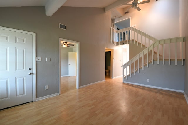7521 Beaudelaire Cir, Galveston, TX 77551 - unfurnished living room featuring ceiling fan, beamed ceiling, baseboards, wood finished floors, and high vaulted ceiling