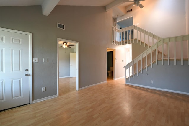 7521 Beaudelaire Cir, Galveston, TX 77551 - unfurnished living room featuring ceiling fan, beamed ceiling, baseboards, wood finished floors, and high vaulted ceiling