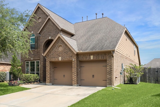 13921 Pebble Falls Ln, Pearland, TX 77584 - view of front of home with brick siding, driveway, roof with shingles, and an attached garage