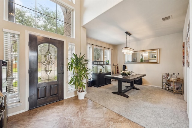 13921 Pebble Falls Ln, Pearland, TX 77584 - entrance foyer with baseboards, light colored carpet, light tile patterned floors, and a chandelier