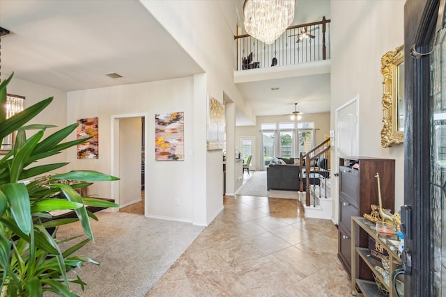 13921 Pebble Falls Ln, Pearland, TX 77584 - foyer featuring a high ceiling, baseboards, a chandelier, tile patterned floors, and carpet