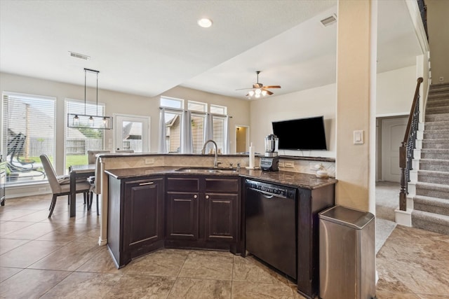 13921 Pebble Falls Ln, Pearland, TX 77584 - kitchen featuring dishwasher, a sink, a ceiling fan, dark brown cabinets, and dark stone countertops