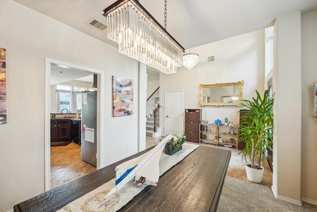 13921 Pebble Falls Ln, Pearland, TX 77584 - dining area featuring a chandelier and stairway