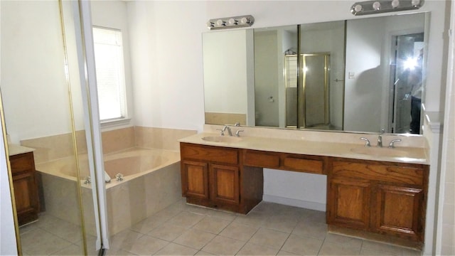 bathroom with a shower stall, a garden tub, double vanity, and a sink