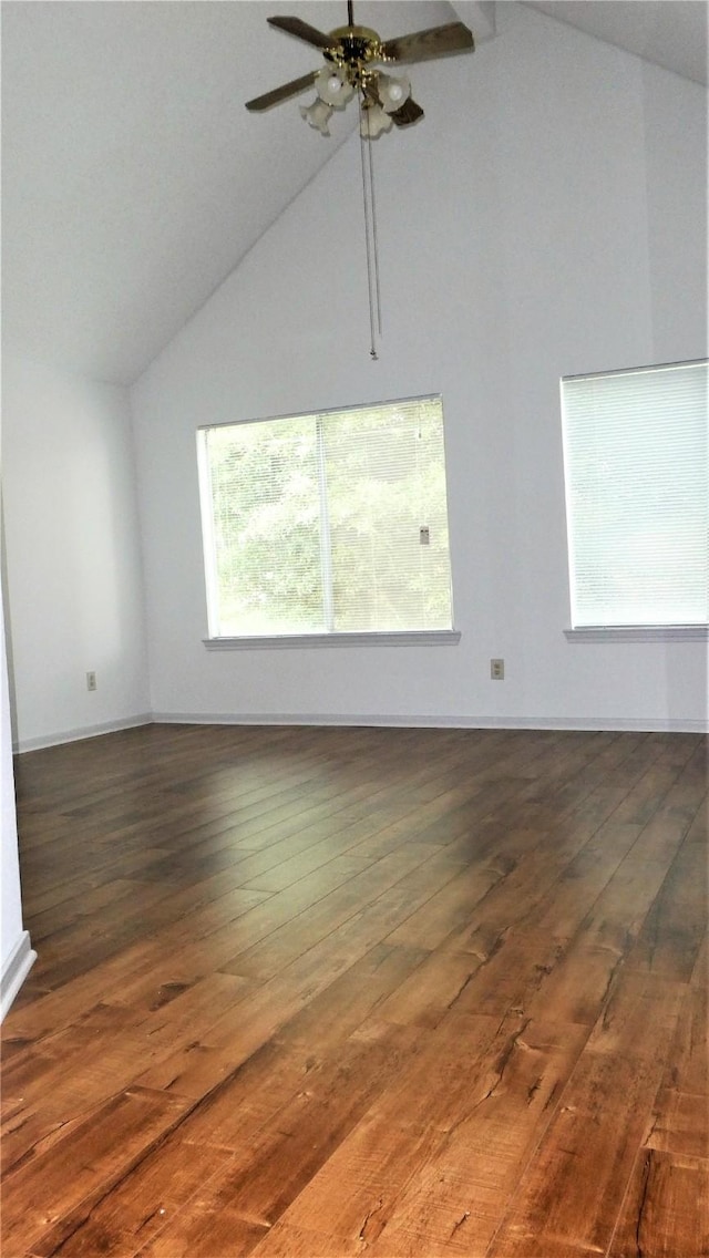 unfurnished room with baseboards, ceiling fan, high vaulted ceiling, and hardwood / wood-style flooring