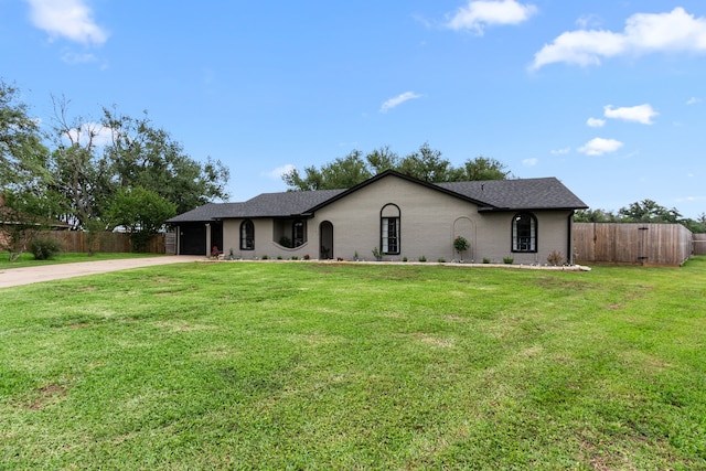 single story home featuring an attached garage, fence, a front yard, and driveway