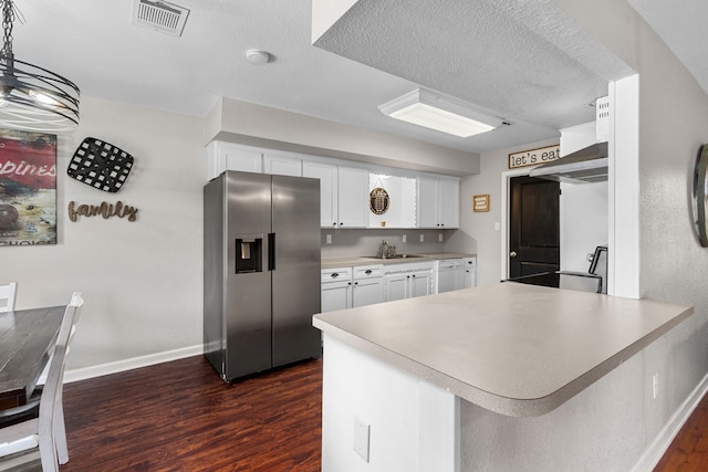 kitchen with stainless steel fridge, baseboards, visible vents, and dark wood-style floors