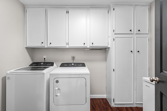 laundry room featuring cabinet space, independent washer and dryer, dark wood-type flooring, and baseboards