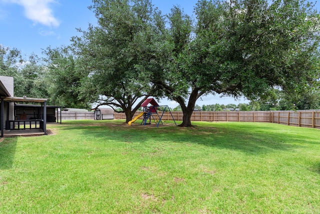 view of yard featuring a playground and a fenced backyard