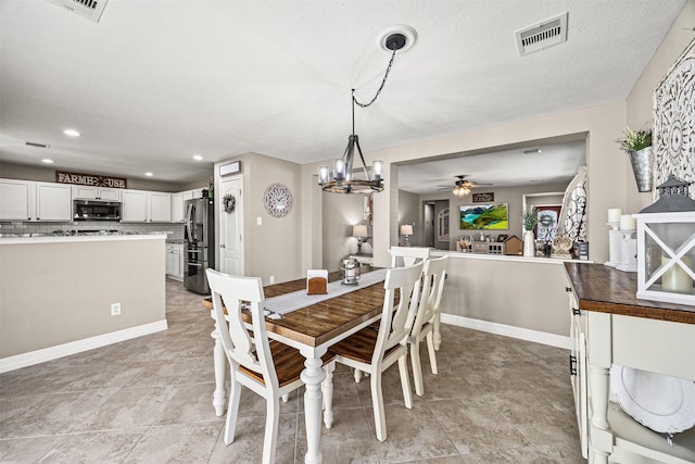 dining room with baseboards, recessed lighting, visible vents, and ceiling fan with notable chandelier