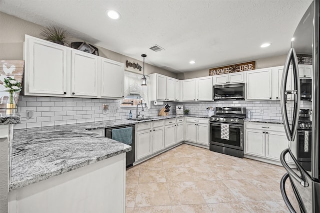 kitchen with a sink, stainless steel appliances, light stone counters, visible vents, and decorative backsplash