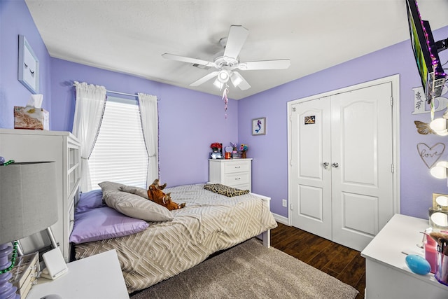 bedroom with a closet, dark wood-style flooring, and ceiling fan