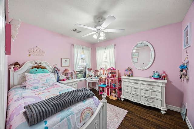 bedroom with baseboards, visible vents, dark wood-style flooring, and a ceiling fan