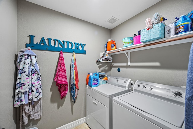 clothes washing area featuring washing machine and dryer, laundry area, baseboards, and visible vents