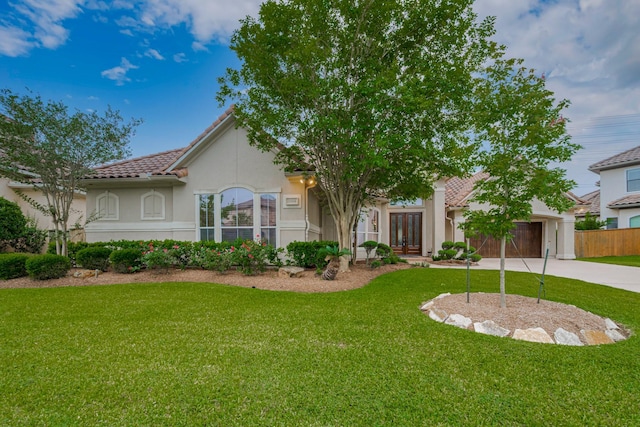 12404 Baymeadow Dr, Pearland, TX 77584 - mediterranean / spanish-style house with driveway, french doors, a tiled roof, stucco siding, and a front yard