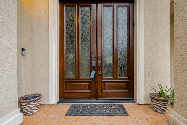 12404 Baymeadow Dr, Pearland, TX 77584 - view of exterior entry featuring stucco siding and french doors