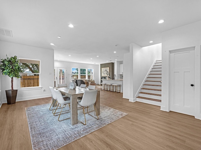dining room with stairs, a wealth of natural light, visible vents, and recessed lighting