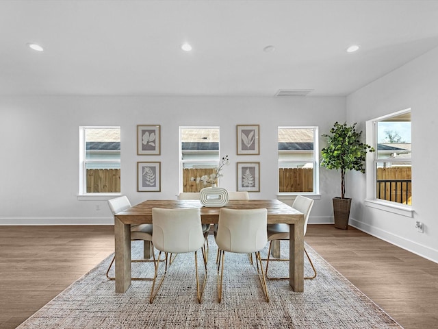 dining space with visible vents, wood finished floors, baseboards, and recessed lighting