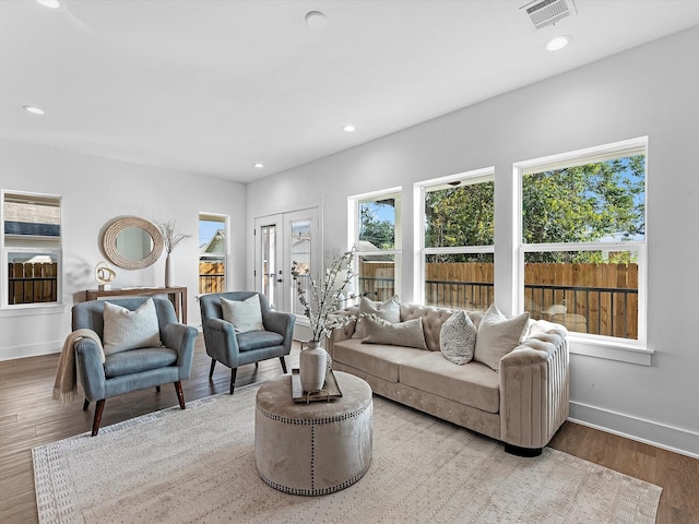 living room featuring french doors, recessed lighting, baseboards, visible vents, and wood finished floors