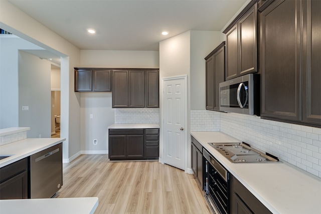 kitchen with light countertops, stainless steel appliances, light wood-style flooring, and dark brown cabinetry