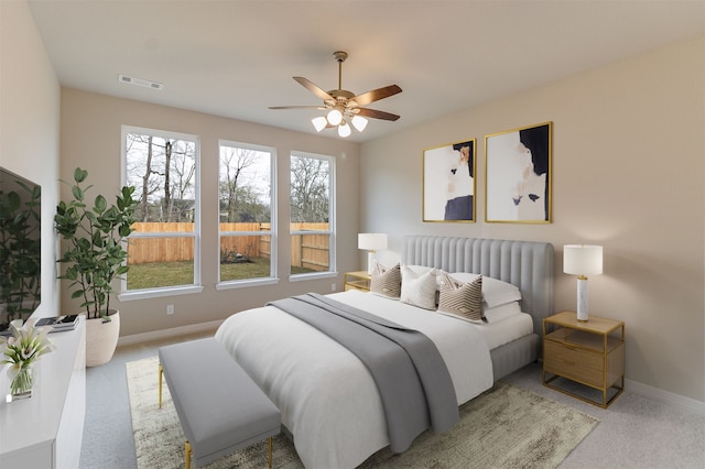 bedroom featuring multiple windows, visible vents, baseboards, and carpet floors